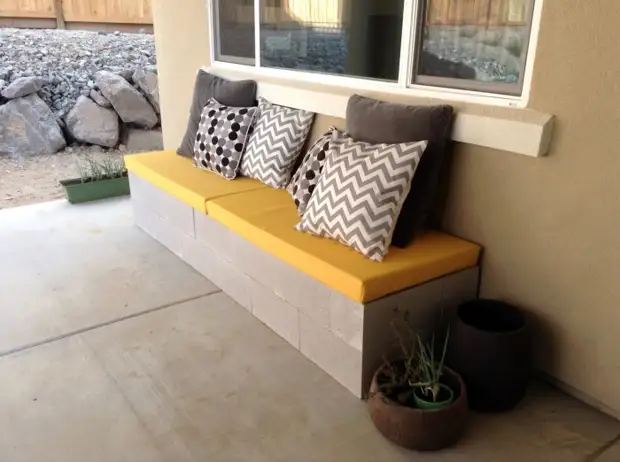 Concrete blocks can be a temporary base for a small sofa in the fresh air.