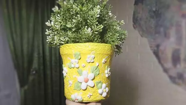 Unusual pot for flowers from plastic bucket for exquisite interior