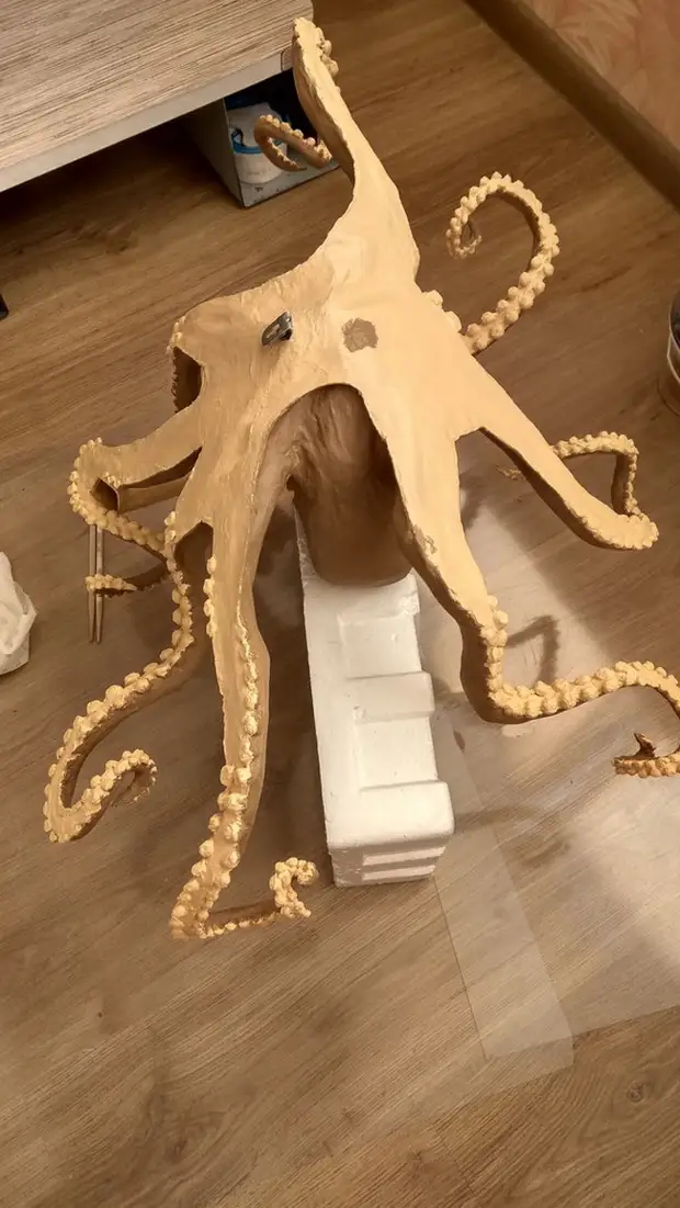 De lampe yn 'e foarm fan in octopus fan Papier-Mâché mei har eigen hannen