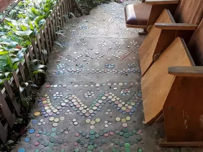 Master decorated her yard, laying out patterns of plastic bottles covers