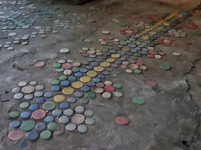 Master decorated her yard, laying out patterns of plastic bottles covers