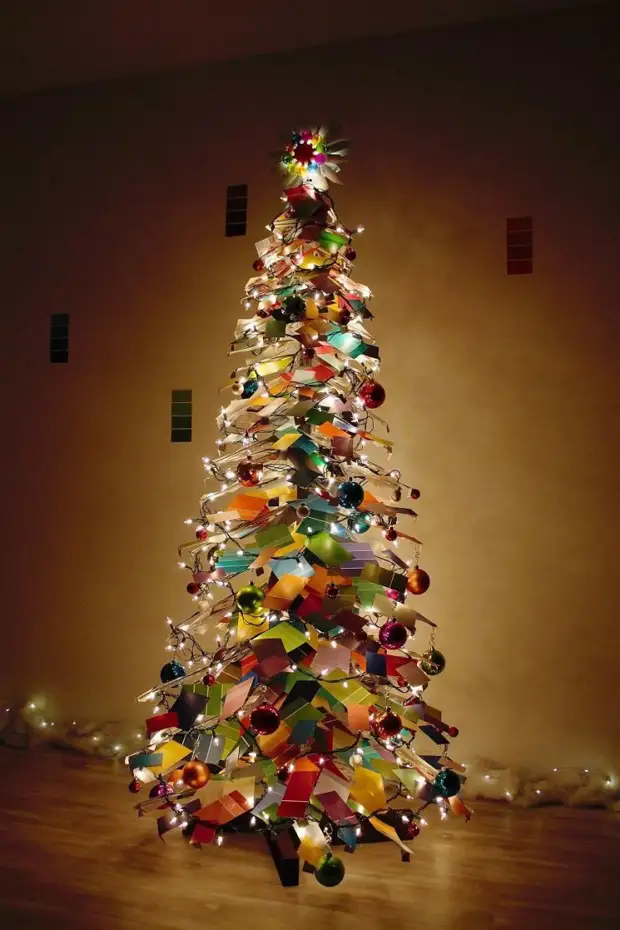 Couple made a christmas tree from paint samples, and in the dark it is especially magnificent