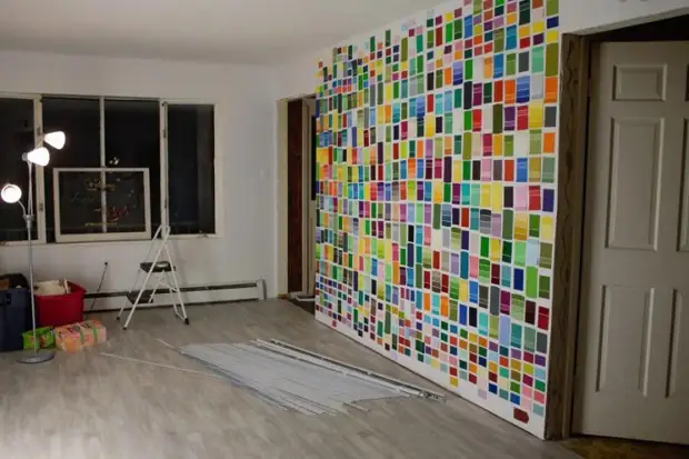 Couple made a christmas tree from paint samples, and in the dark it is especially magnificent